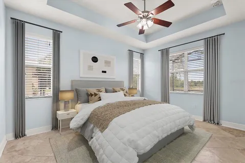 a bedroom with a large bed and a ceiling fan