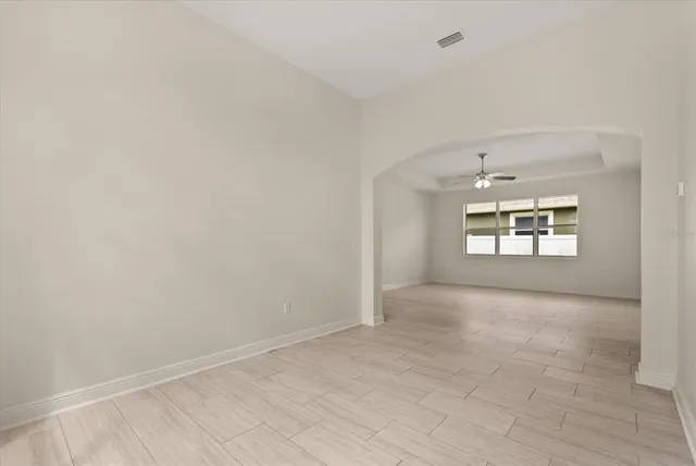 an empty room with a empty space and windows