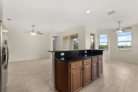 a kitchen with granite countertop a sink and cabinets