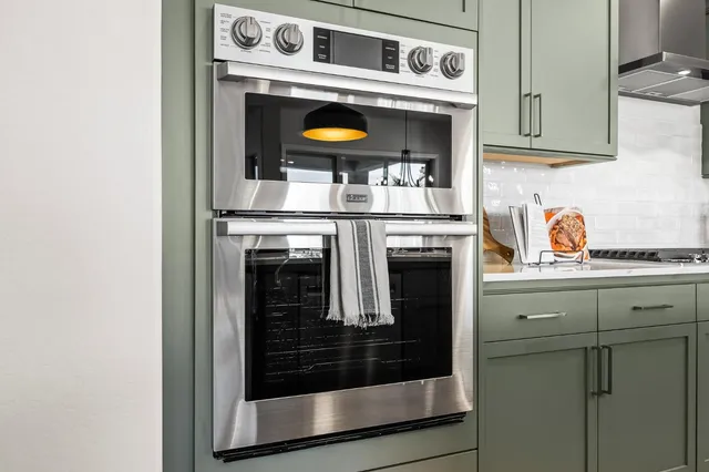 a stove top oven sitting inside of a kitchen