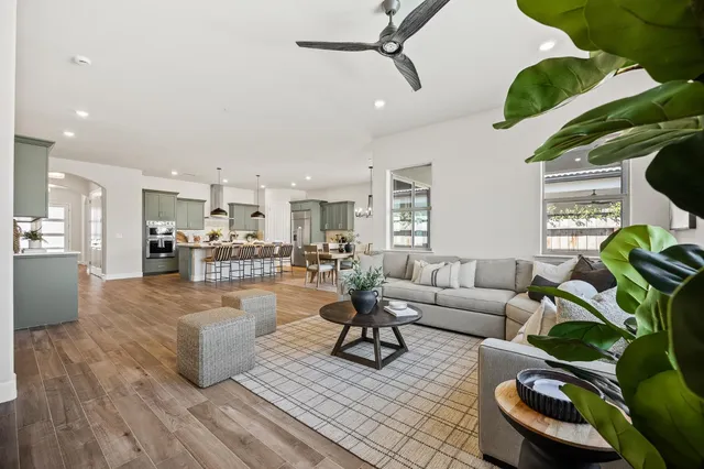 a living room with furniture and a wooden floor