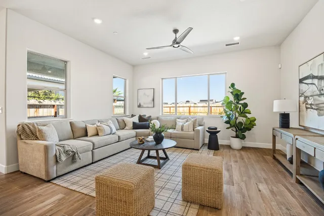 a living room with furniture or wooden floor and a large window
