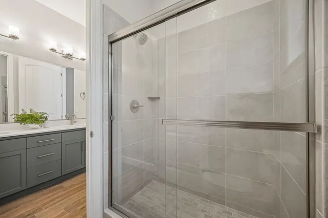 a bathroom with a shower and a sink