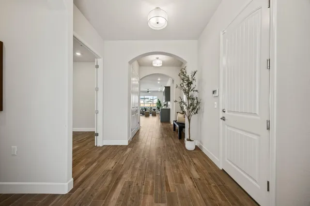 a view of a hallway with wooden floor