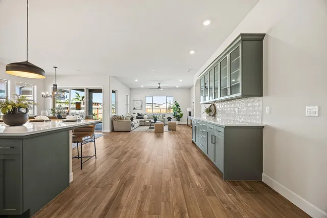 a view of living room kitchen with stainless steel appliances granite countertop lots of counter top space