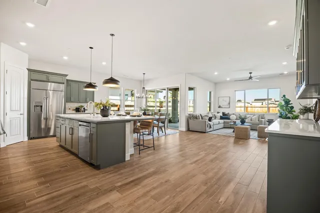 a kitchen with counter top space a sink appliances and cabinets