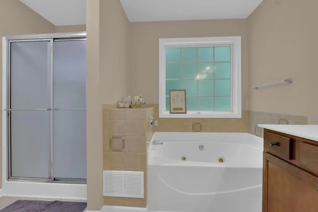 a bathroom with a bathtub and shower