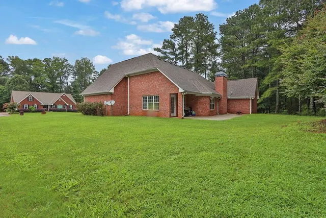 a front view of house with yard and green space
