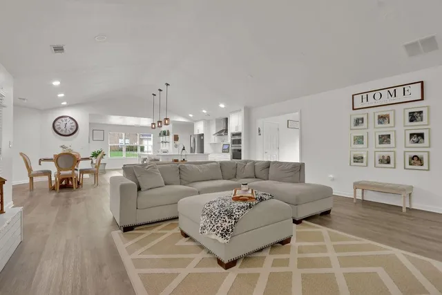 a living room with furniture and a chandelier