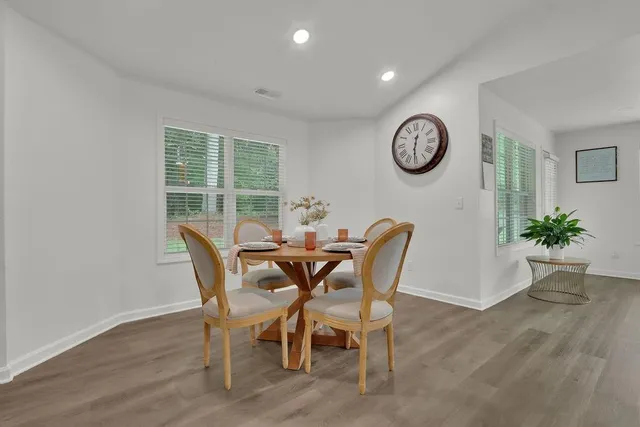 a view of a dining room with furniture window and wooden floor