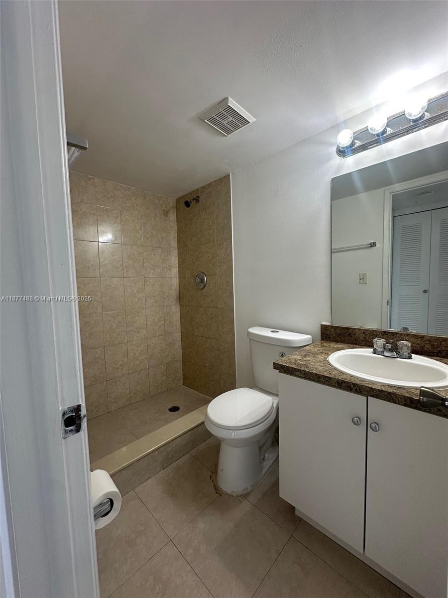 7125 Northwest 186th Street, Unit B208 Hialeah, FL 33015 - Photo 7 of 10 a bathroom with a sink a toilet and shower