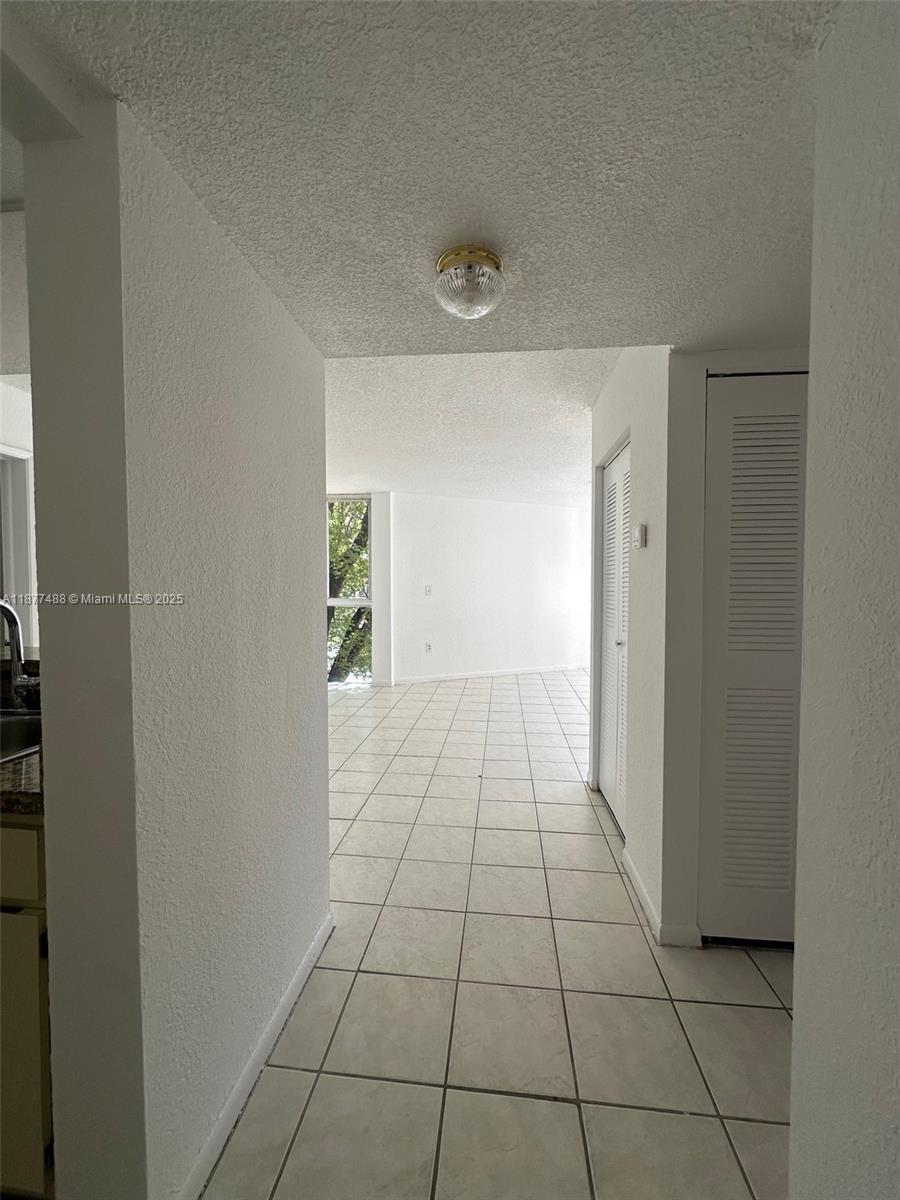 7125 Northwest 186th Street, Unit B208 Hialeah, FL 33015 - Photo 10 of 10 a view of an empty room and window