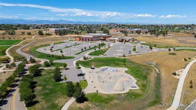 an aerial view of a house with yard swimming pool and ocean view