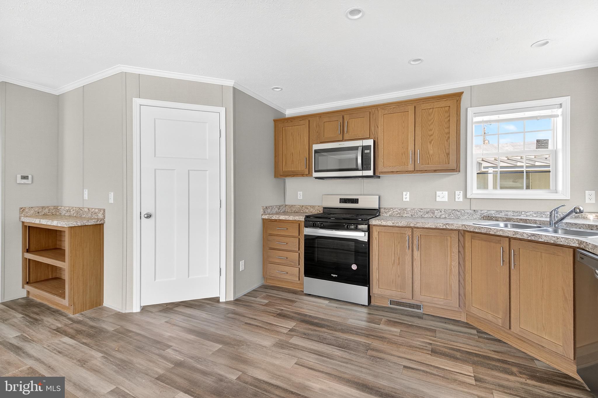 313 Bordic Road Reading, PA 19606 - Photo 18 of 27 a kitchen with stainless steel appliances granite countertop a stove a sink and a microwave