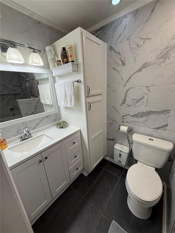 7223 Tarrytown Drive Spring Hill, FL 34606 - Photo 16 of 27 a white toilet sitting next to a bathroom sink and vanity