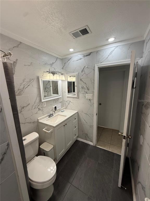 7223 Tarrytown Drive Spring Hill, FL 34606 - Photo 18 of 27 a bathroom with a toilet sink and mirror