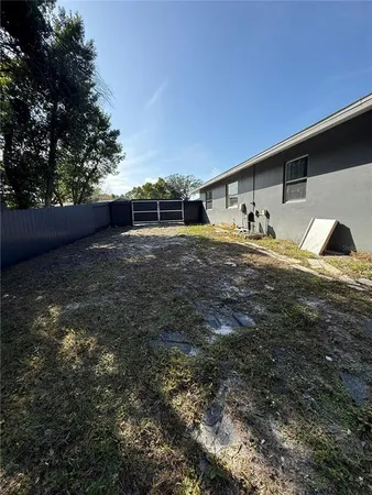 a view of backyard with parked car