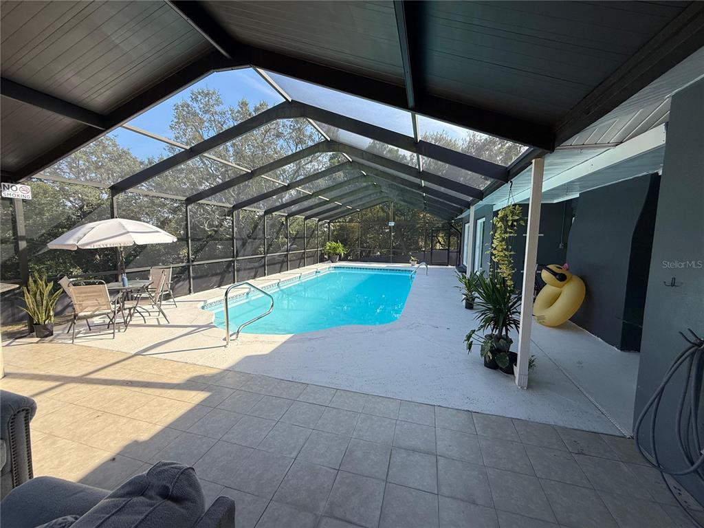 7223 Tarrytown Drive Spring Hill, FL 34606 - Photo 26 of 27 a view of a chairs and table in the patio