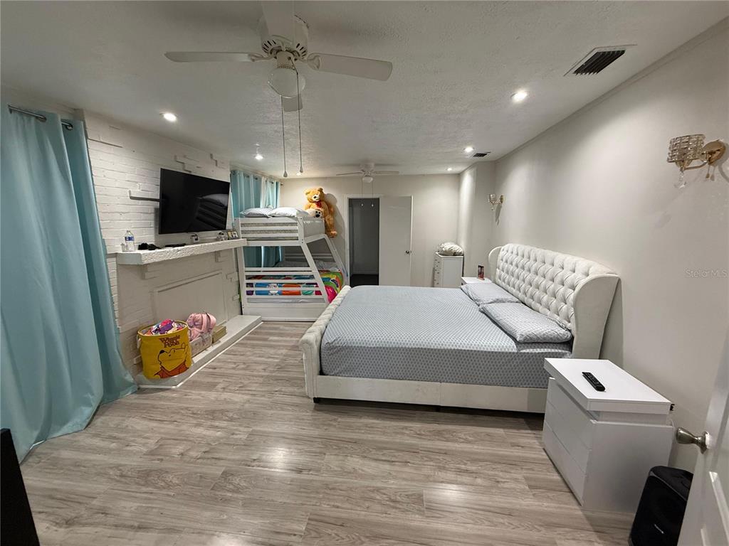 7223 Tarrytown Drive Spring Hill, FL 34606 - Photo 8 of 27 a living room with furniture and a flat screen tv