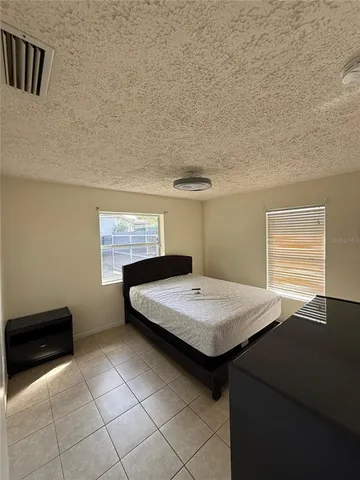 a room with pool table and window