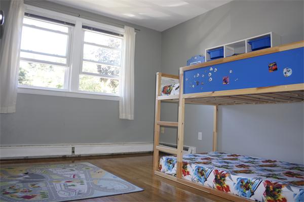 52 David Needham, MA 02494 - Photo 14 of 22 a living room with furniture and a book shelf