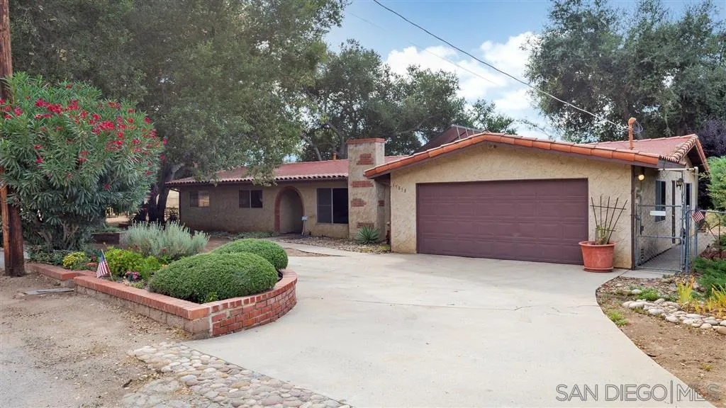 15858 Mussey Grade Road Ramona, CA 92065 - Photo 1 of 1 a front view of a house with a garden