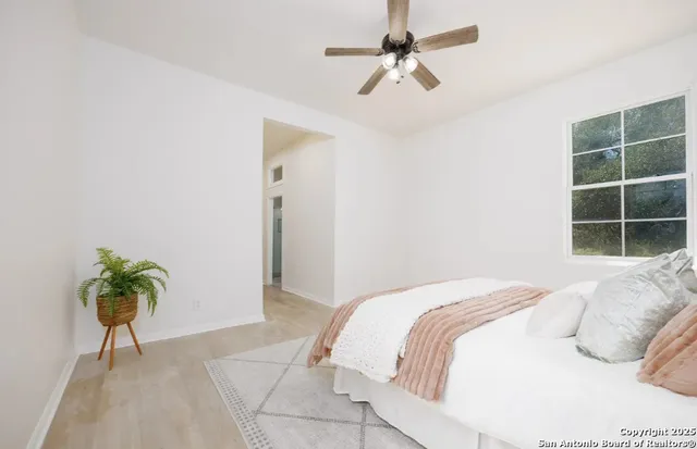 a bedroom with a bed and a potted plant