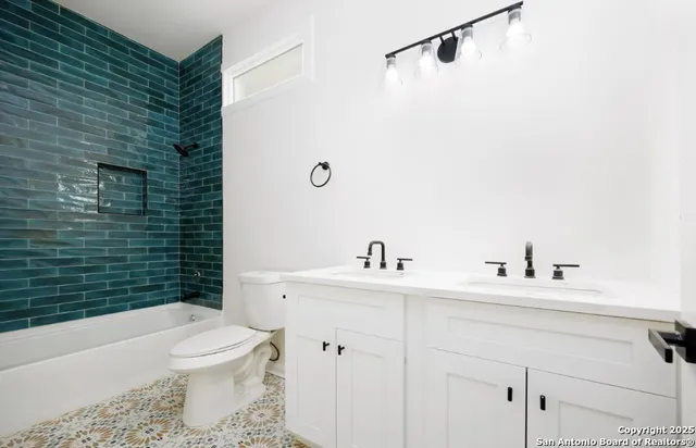 a bathroom with a sink toilet and shower