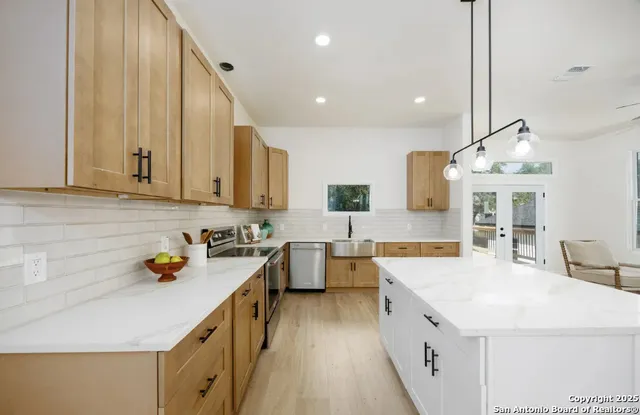 a kitchen with a sink stove and wooden cabinets