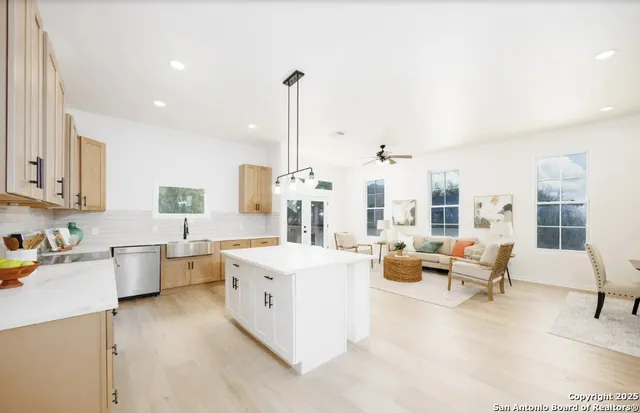 a large white kitchen with stainless steel appliances