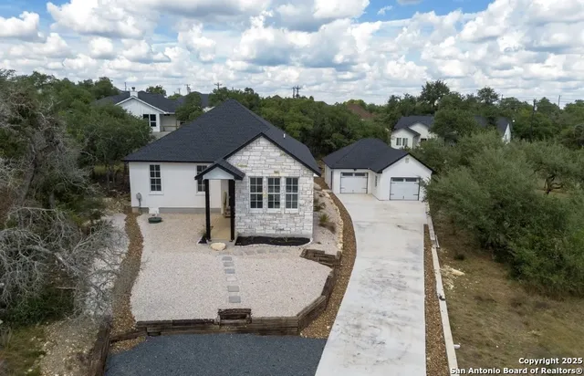 a view of house with outdoor space and sitting area