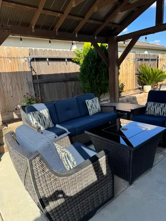 a outdoor living space with furniture and a fireplace