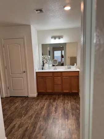 a bathroom with a double vanity sink mirror and shower