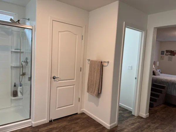 a bedroom with furniture and a flat screen tv