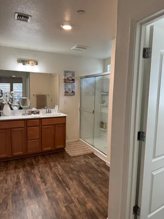 a living room with furniture kitchen and a wooden floor
