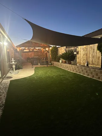 a view of a backyard with sitting area