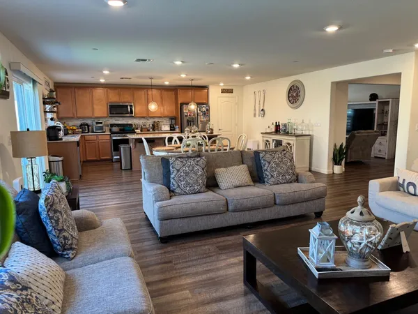 a living room with furniture kitchen and a table