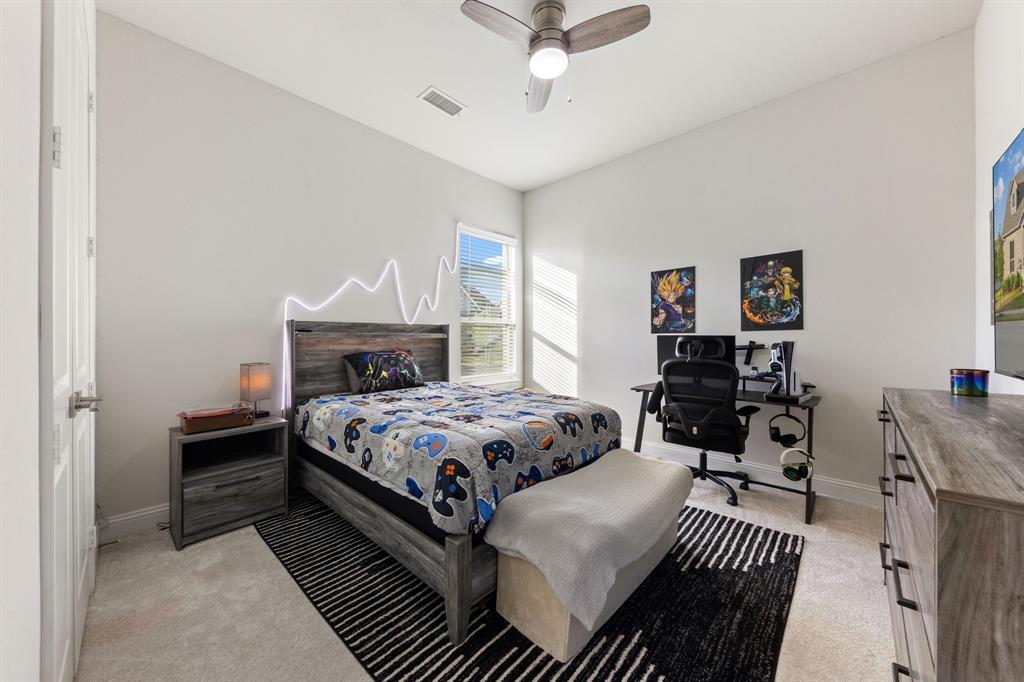 8808 Royal Star Road Rowlett, TX 75089 - Photo 31 of 40 a bedroom with a bed and a chandelier
