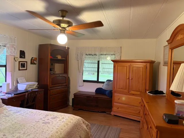 a bedroom with a bed dresser and a window