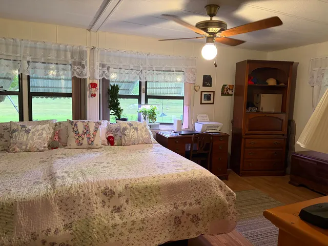 a bed room with a bed and a large window