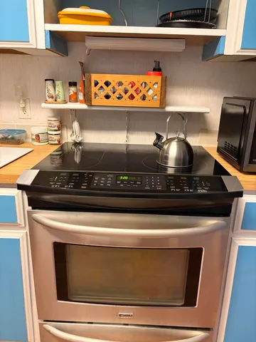 a stove top oven sitting inside of a kitchen