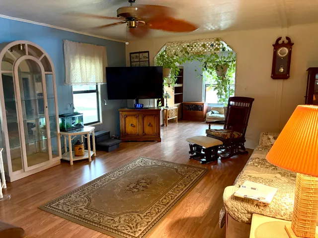a living room with furniture and a wooden floor
