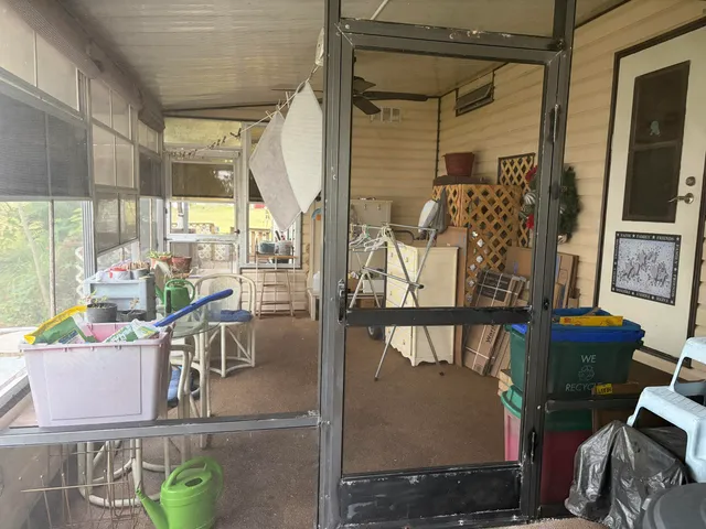 a view of a living room with a table and chairs