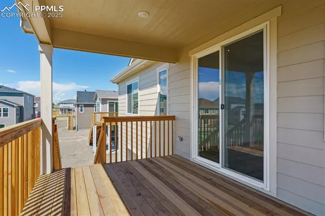 a view of a balcony with floor to ceiling window with wooden floor