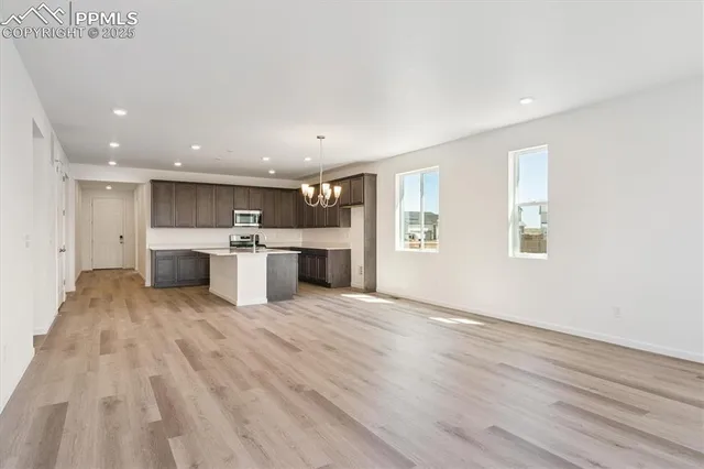a view of kitchen with white cabinets and wooden floor