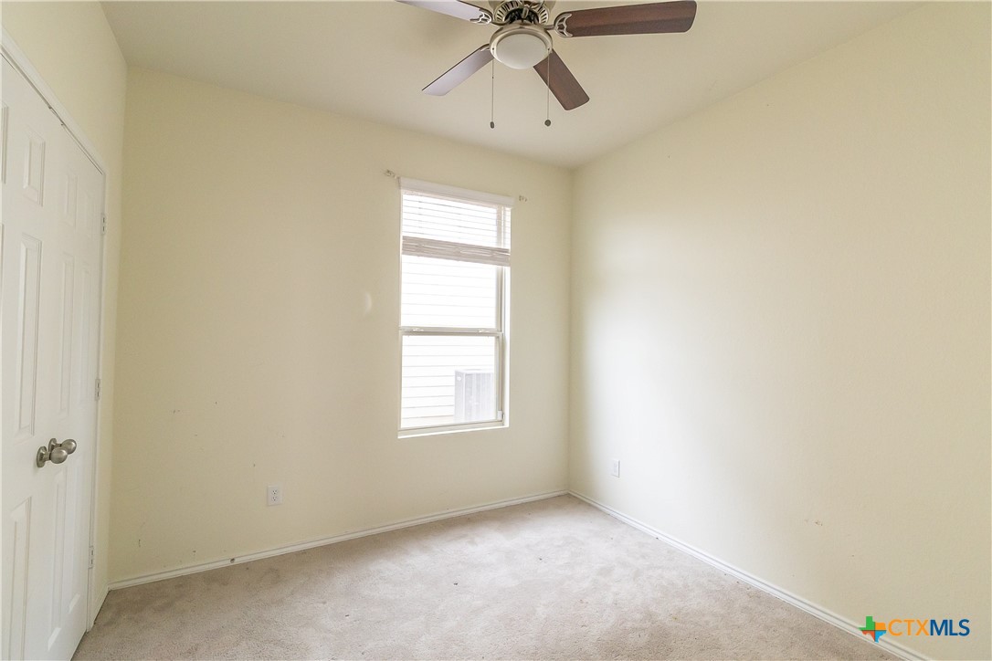 145 Miracle Drive Jarrell, TX 76537 - Photo 13 of 23 an empty room with a window and a fan