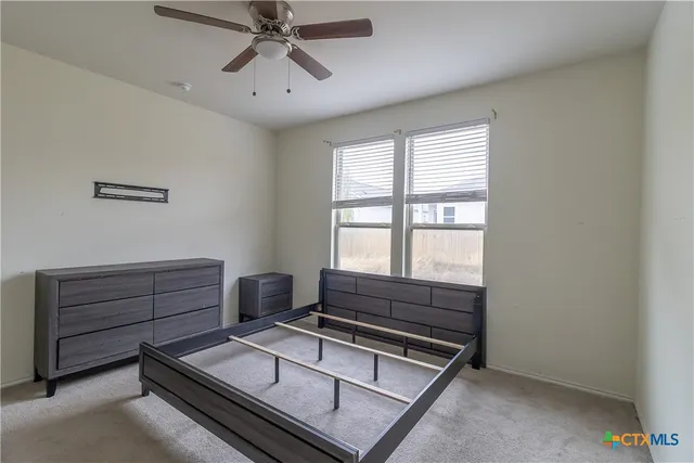 a room with furniture and a ceiling fan