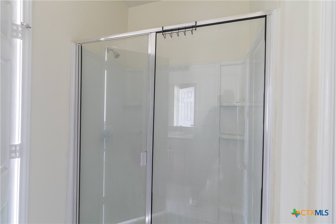145 Miracle Drive Jarrell, TX 76537 - Photo 20 of 23 a bathroom with a glass shower door