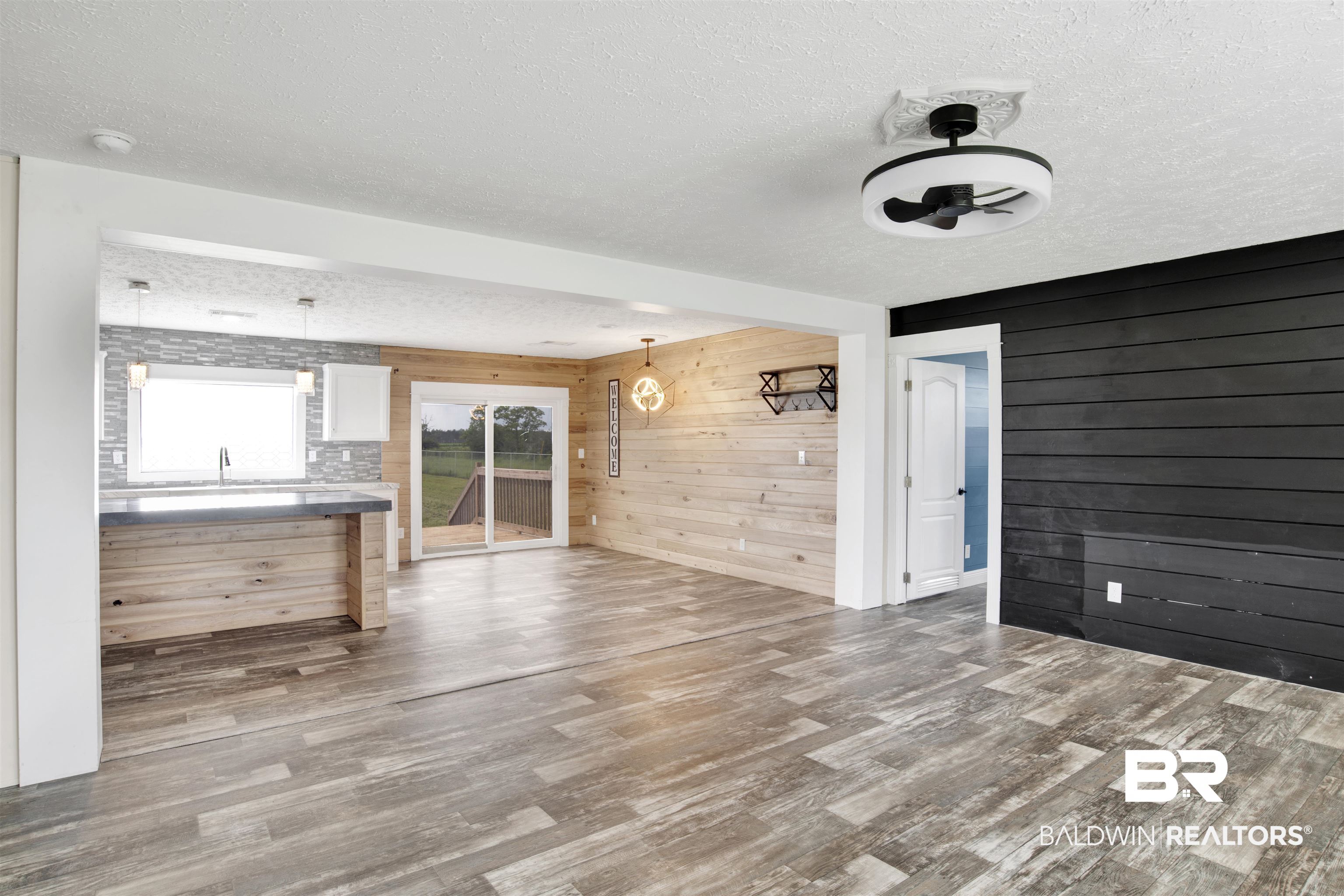 16778 County Road 87 Elberta, AL 36530 - Photo 12 of 32 Interior space featuring a textured ceiling, hardwood / wood-style flooring, wooden walls, and ceiling fan