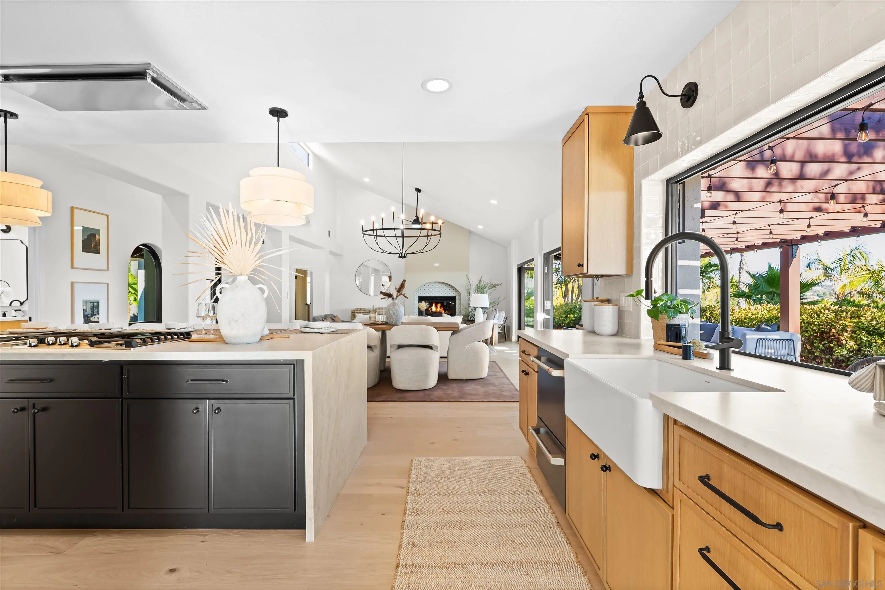 1170 Rancho Encinitas Drive Encinitas, CA 92024 - Photo 16 of 72 a large kitchen with kitchen island a large counter space a sink stainless steel appliances and cabinets